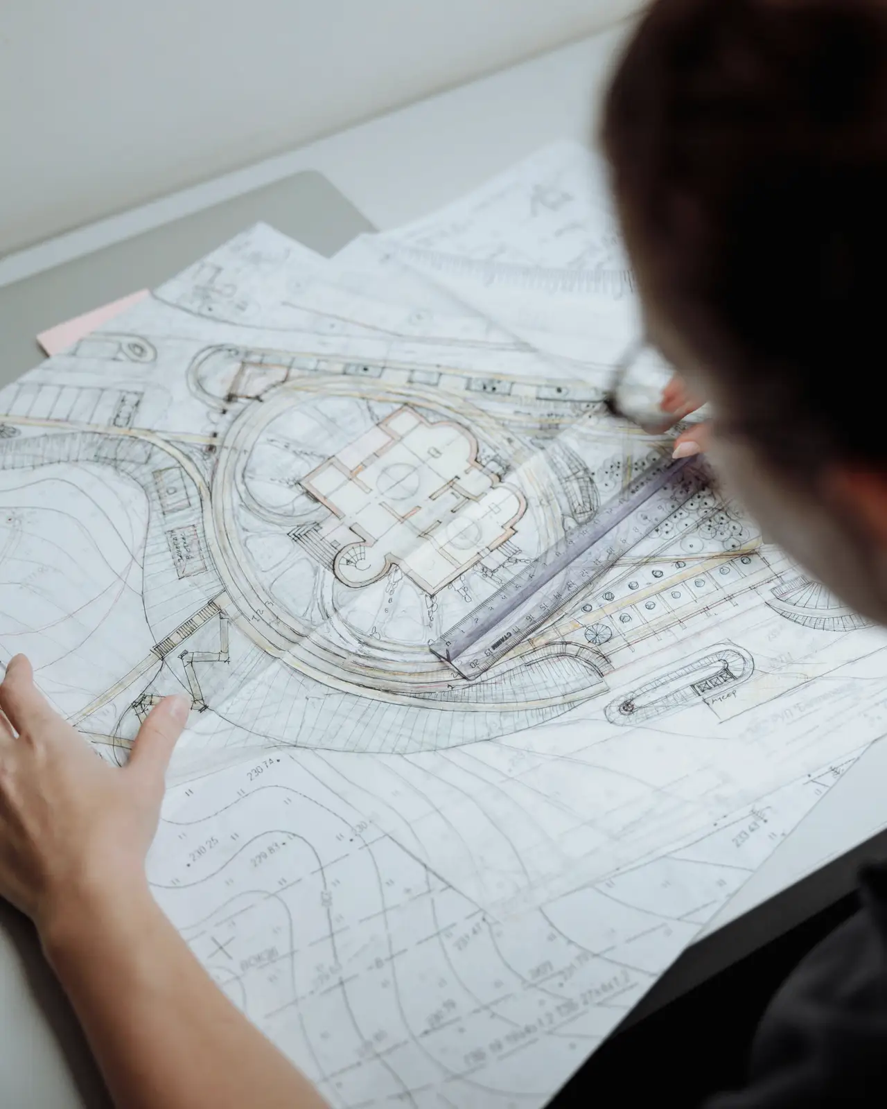Two people reviewing a printed plan at a table